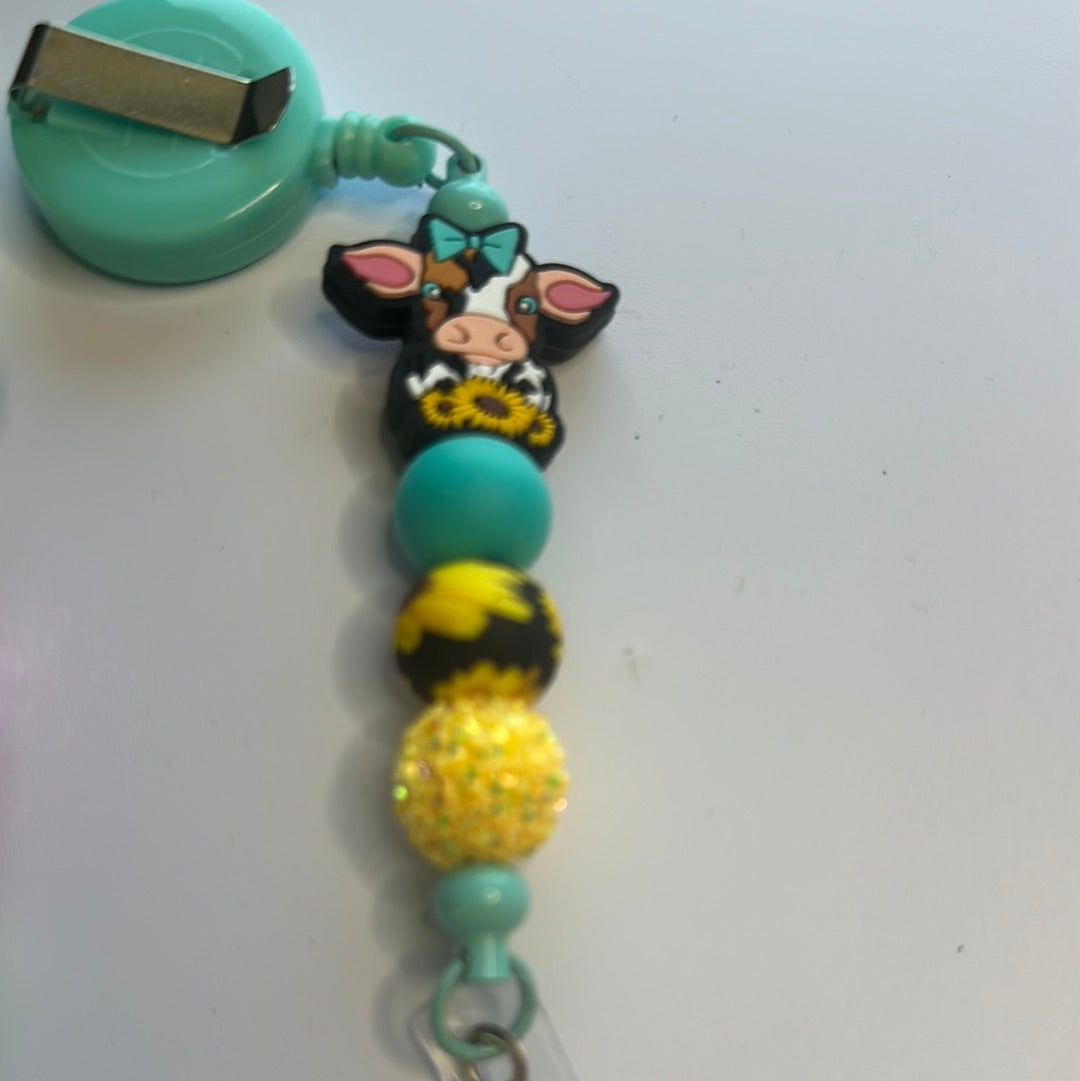 Cow with sunflower beaded badge reel