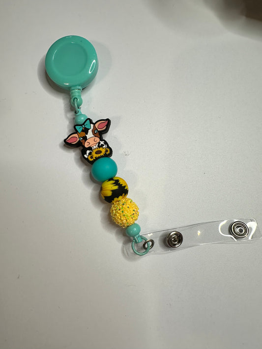 Cow with sunflower beaded badge reel