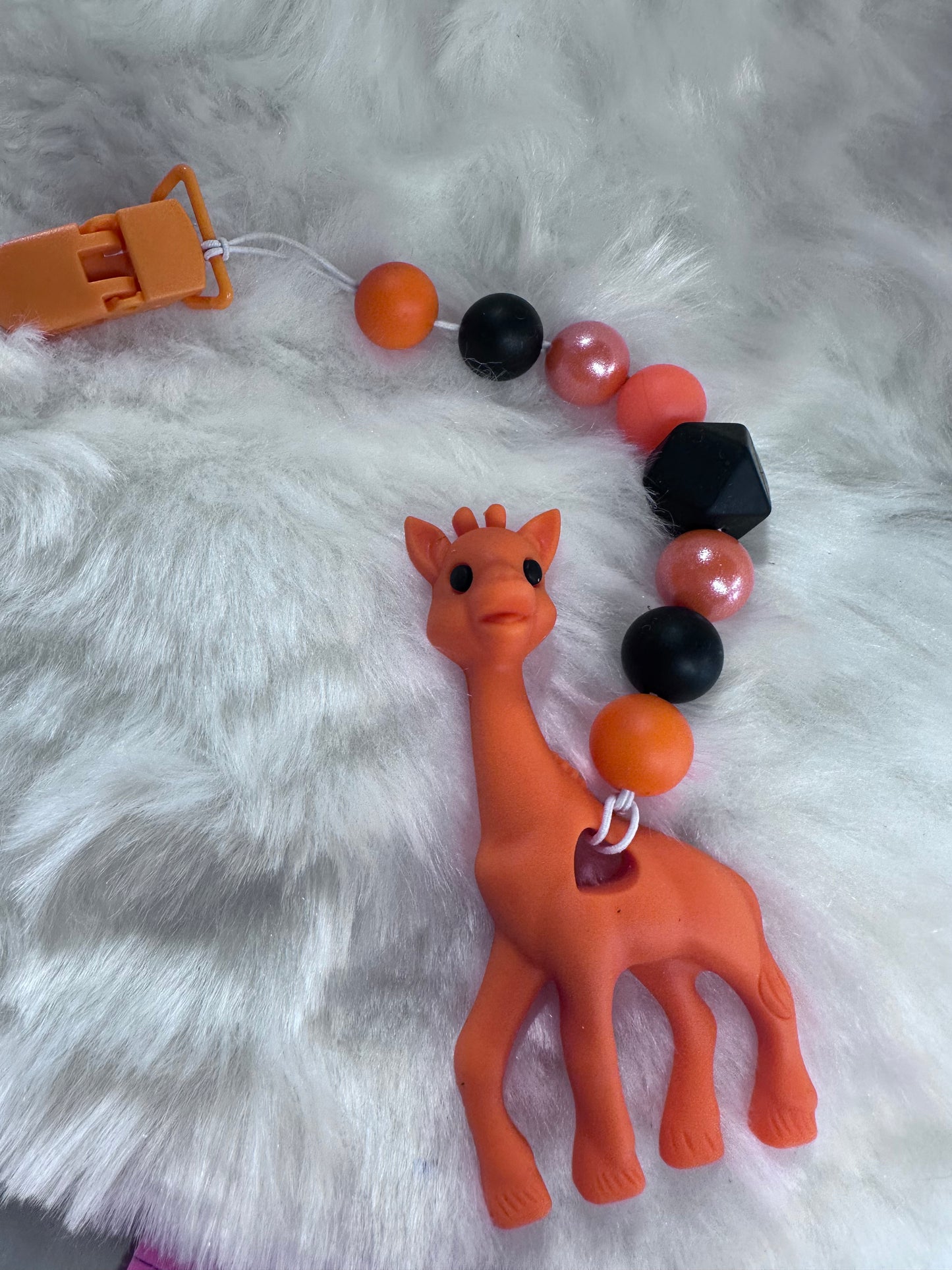 Orange giraffe teether with clip